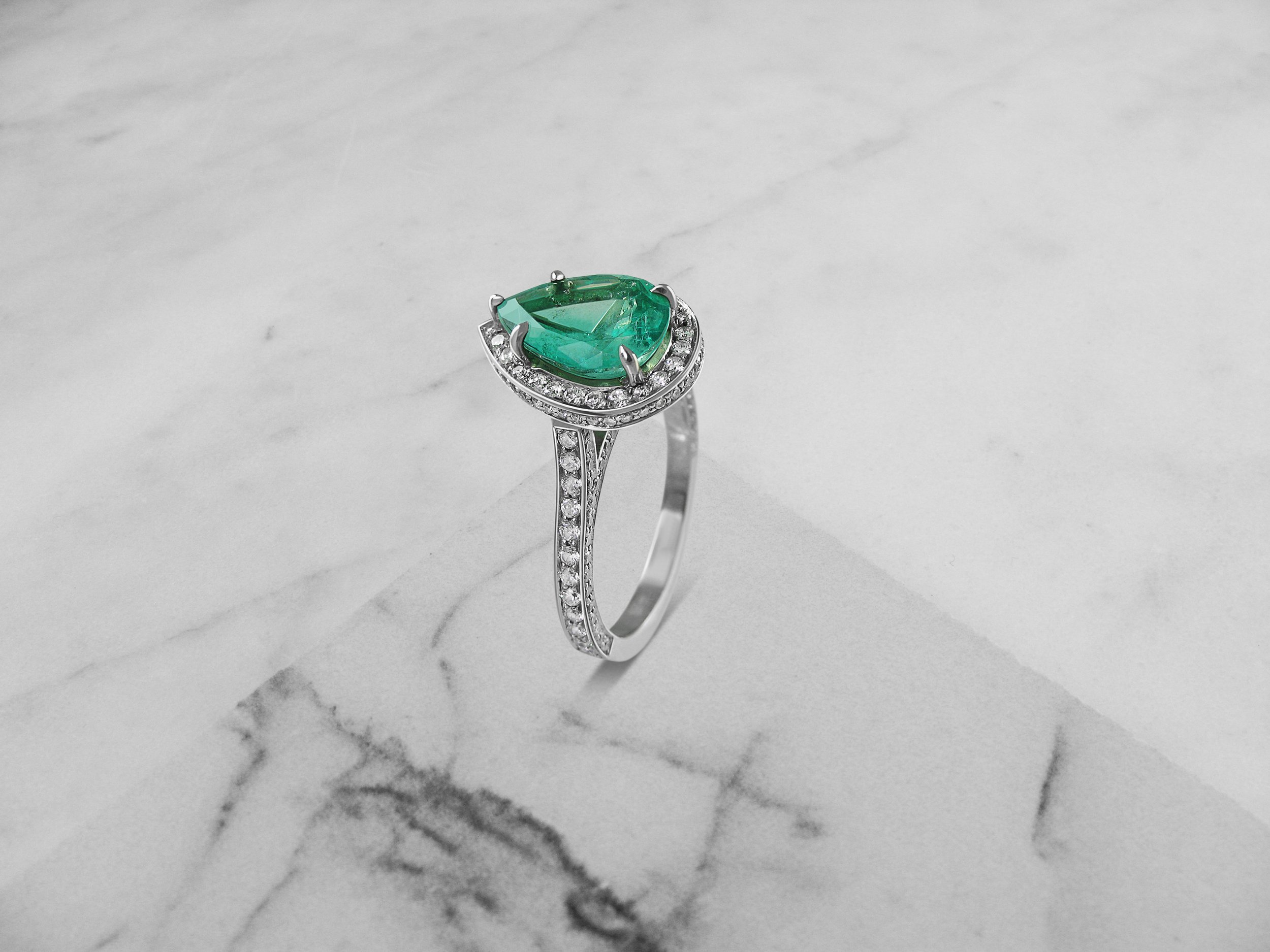 Epic pear shaped emerald and diamond halo ring