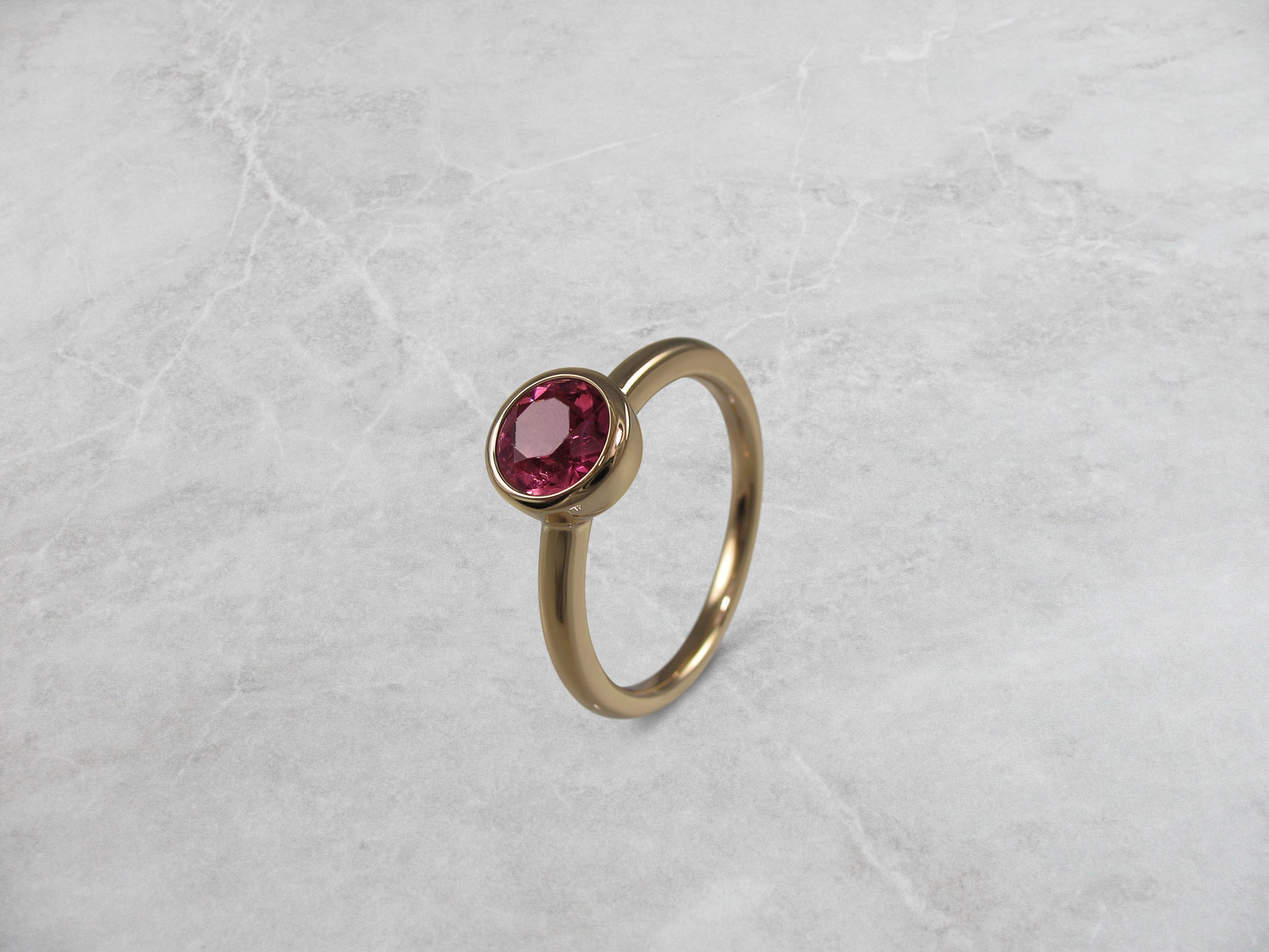 Red tourmaline and gold dress ring