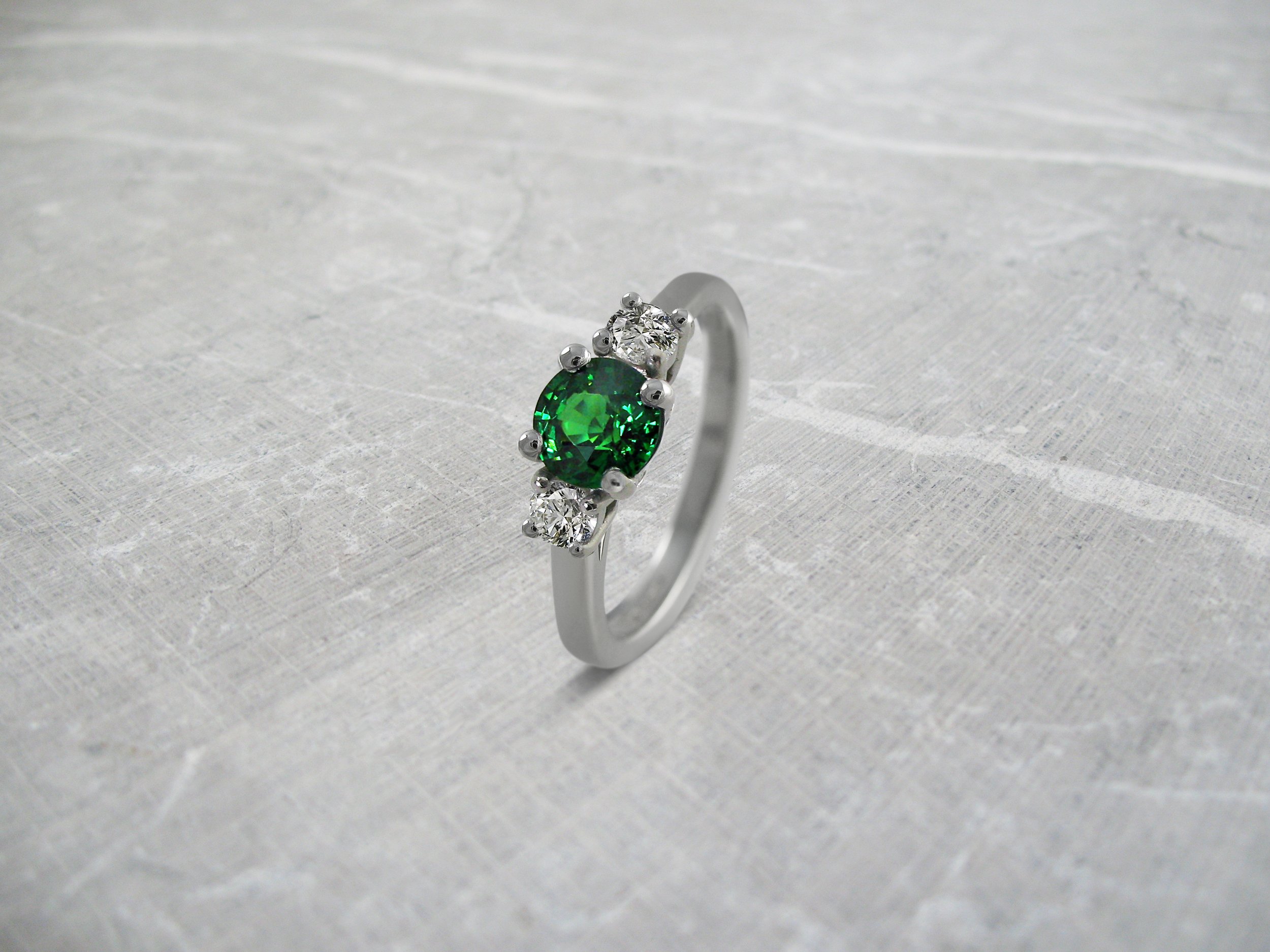 Tsavorite and diamond engagement ring