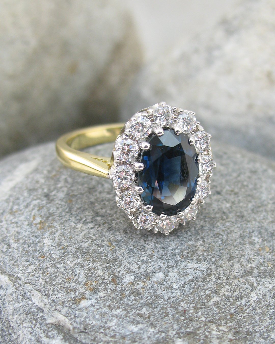 A coronet set oval cut blue sapphire engagement ring