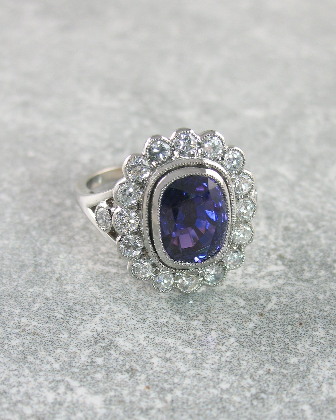 An incredible purple-hued sapphire and diamond halo ring