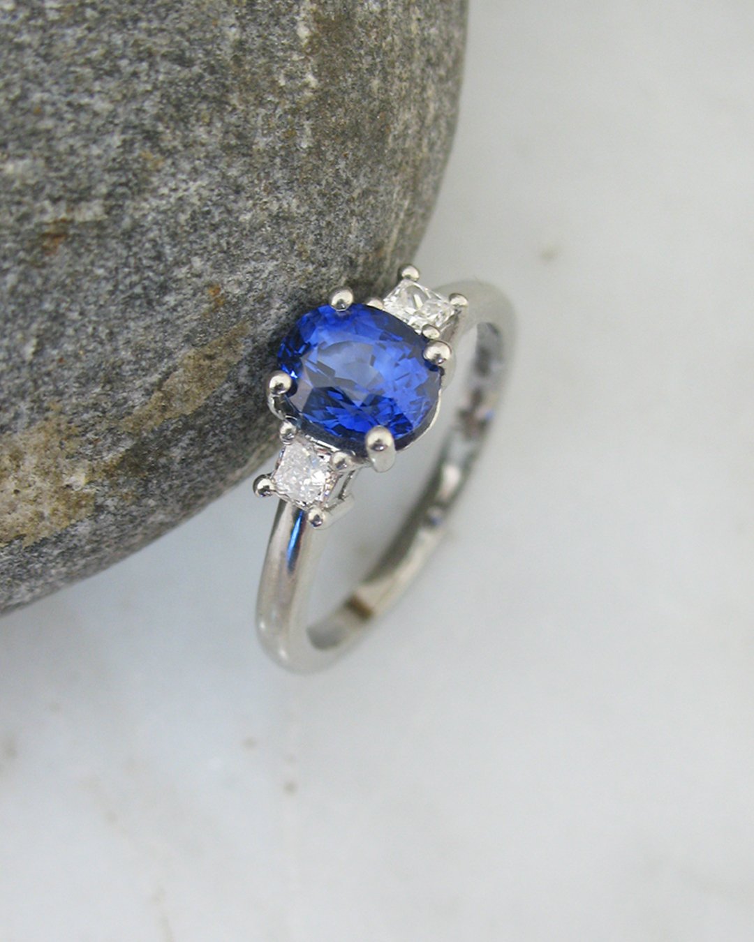 A princess cut diamond and oval sapphire engagement ring