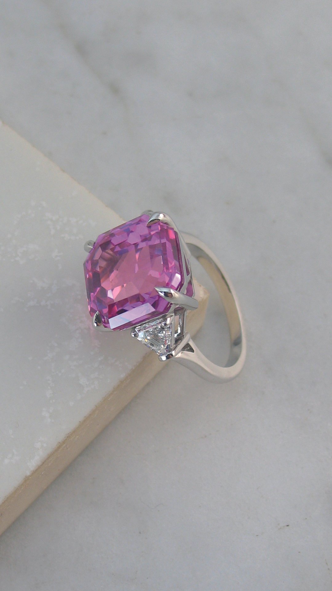 A dazzling Asscher cut pink sapphire and diamond ring