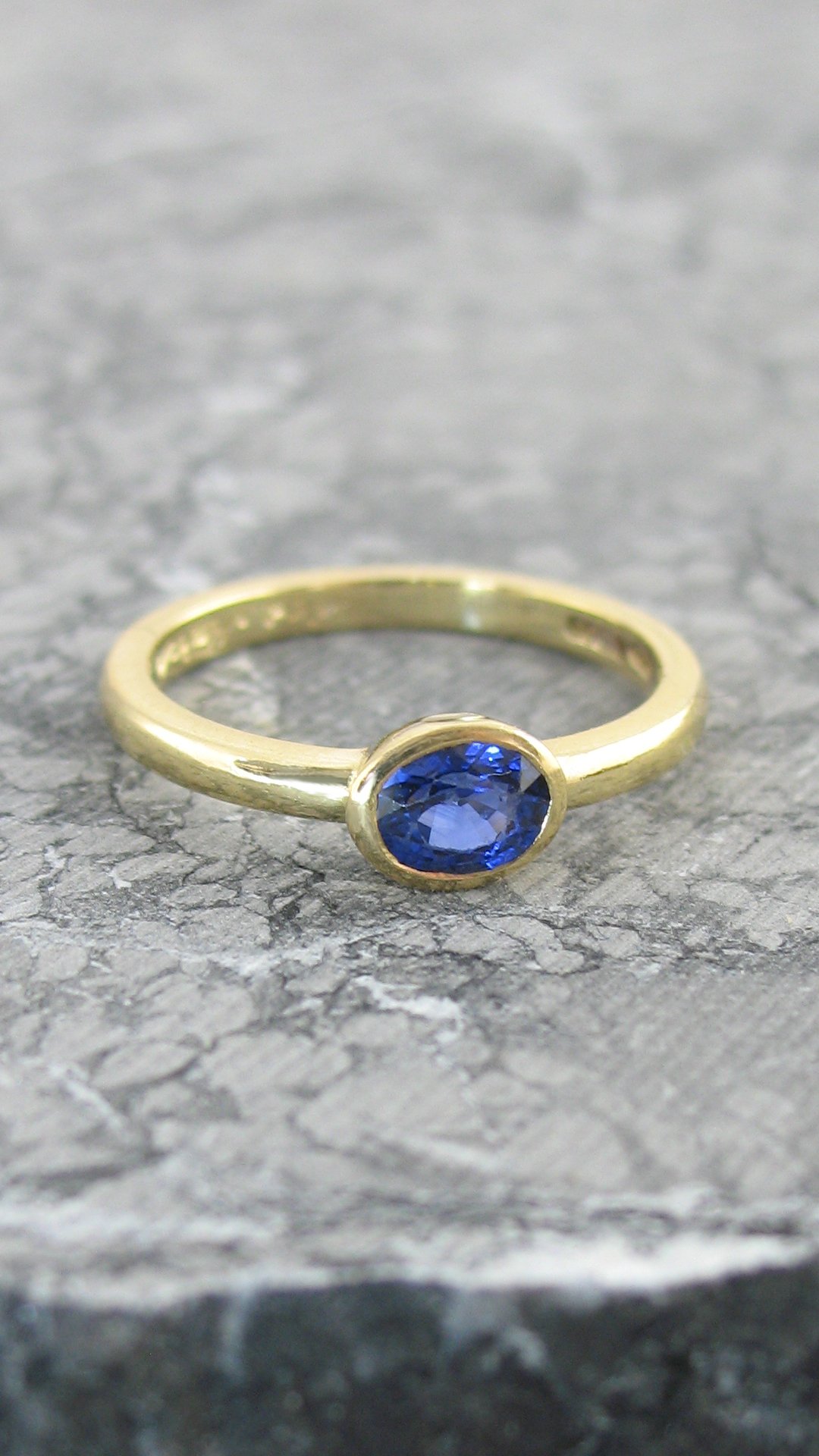 A beautiful bezel set oval sapphire ring 