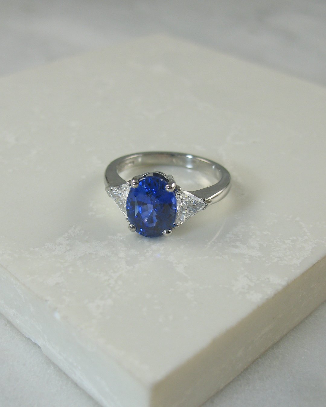 A bespoke sapphire engagement ring with diamond shoulders
