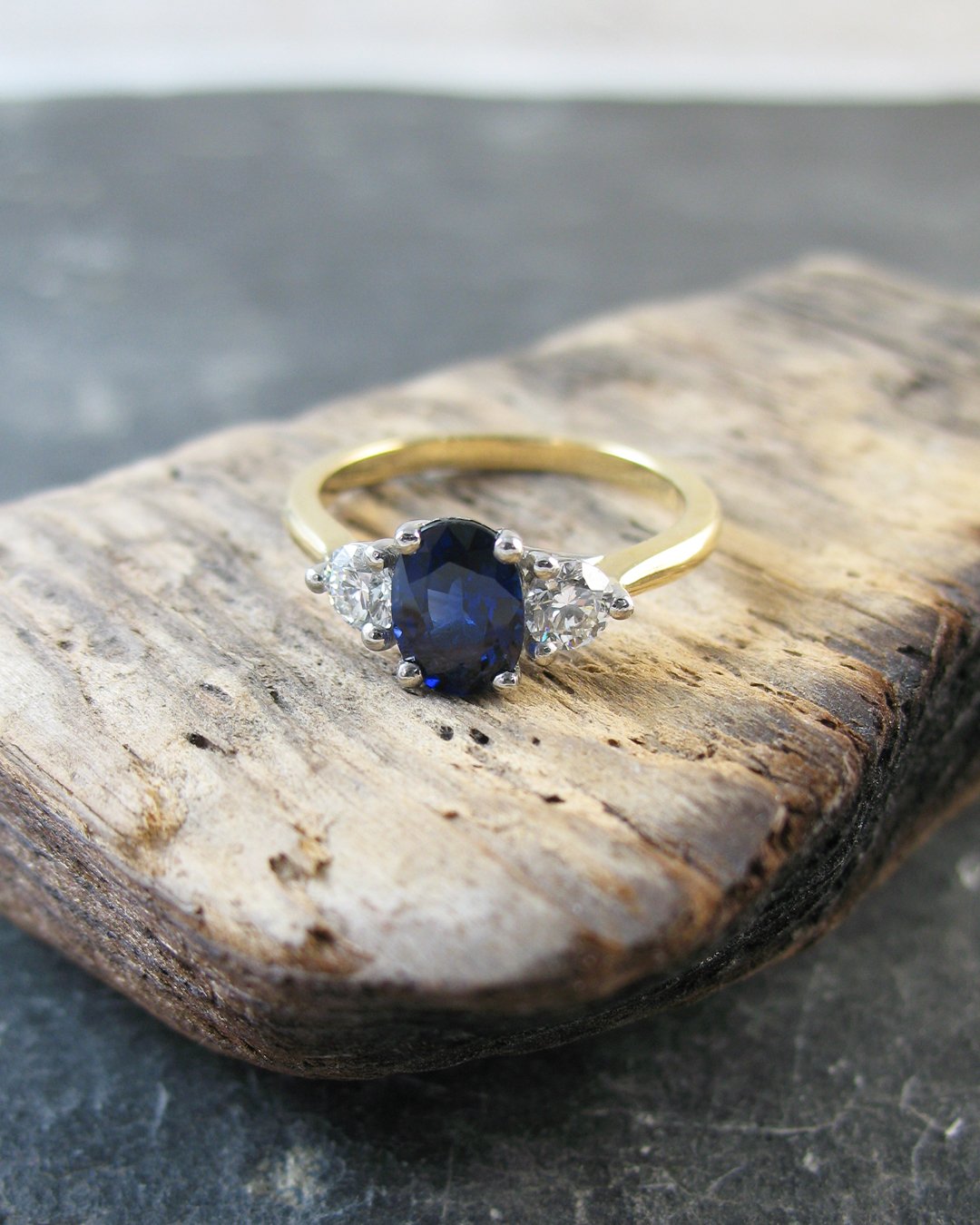 An attractive blue sapphire engagement ring featuring diamonds