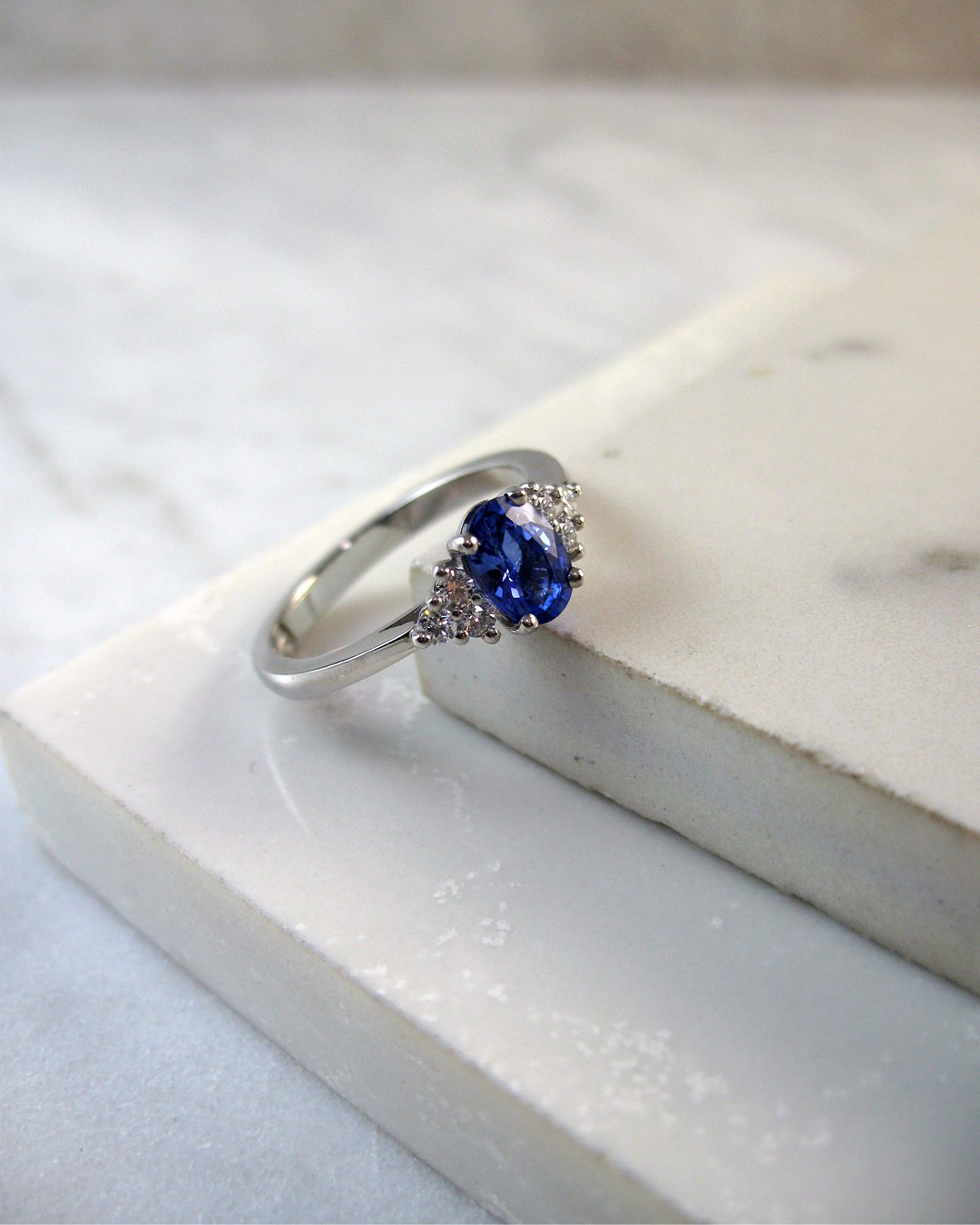 A stunning diamond and sapphire engagement ring in our trefoil design
