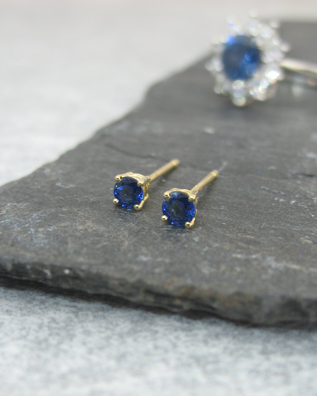 A set of four claw sapphire stud earrings