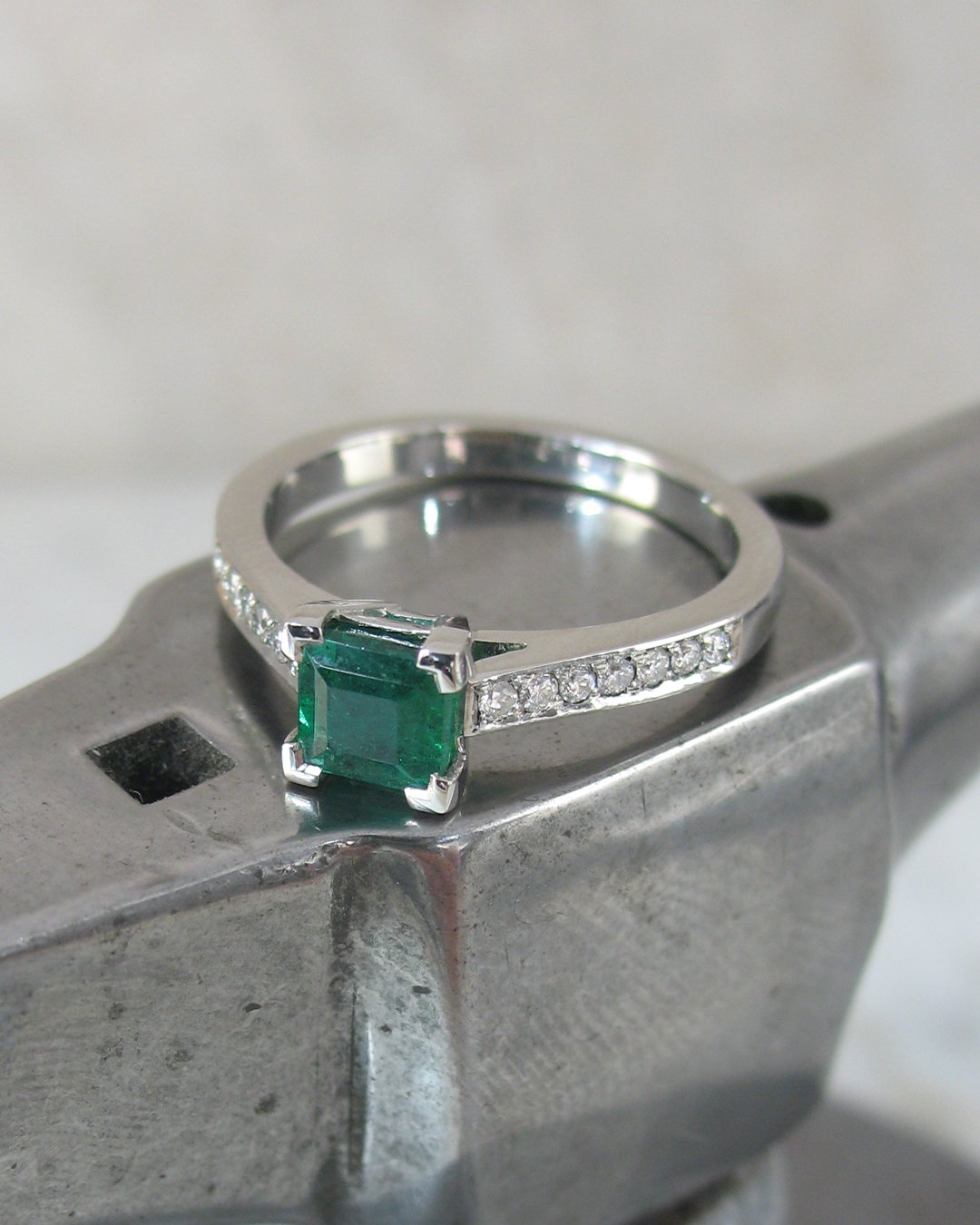 An attractive platinum square cut emerald engagement ring 