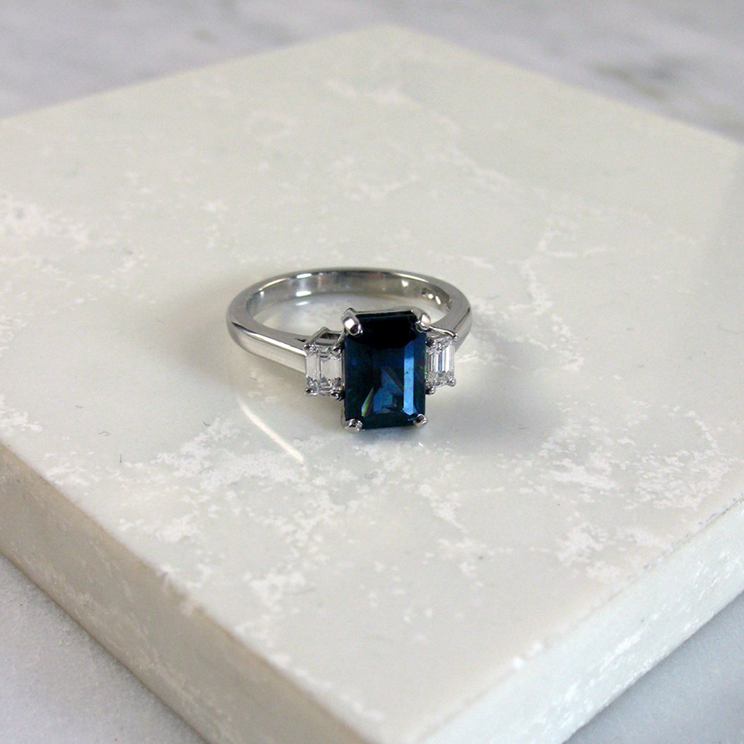 A beautiful teal coloured octagonal step cut sapphire ring 