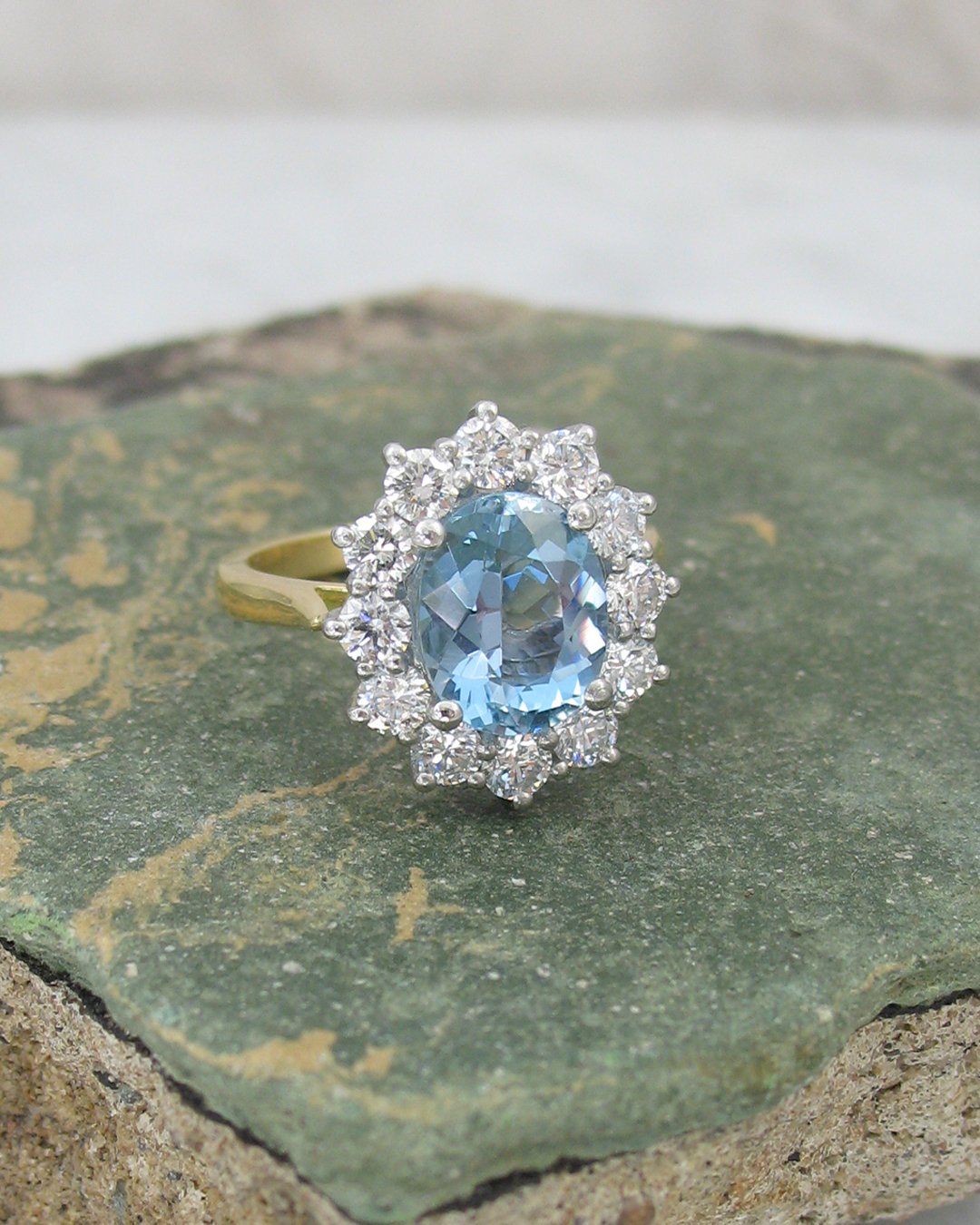 A vintage inspired oval aquamarine cluster ring