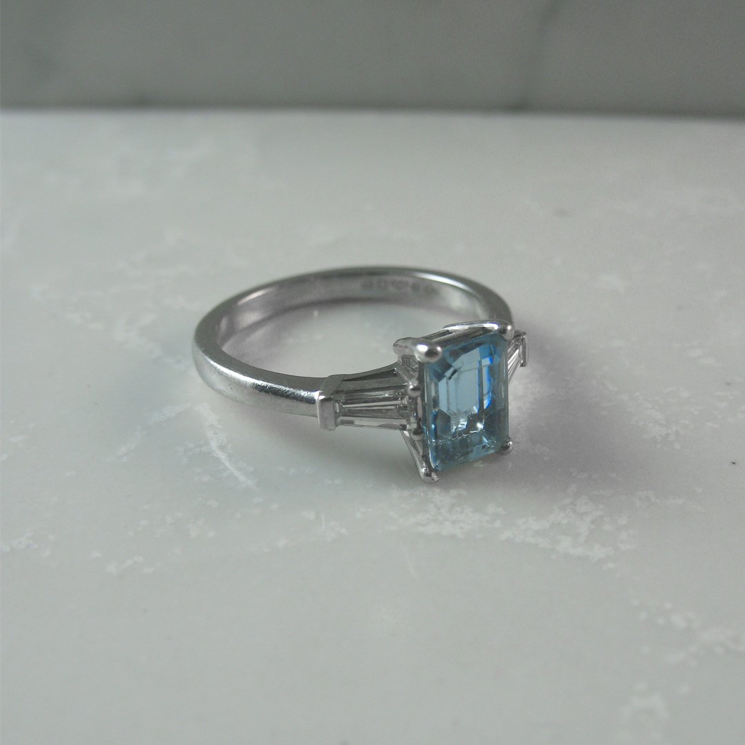 A classic baguette diamond and aquamarine engagement ring.jpg