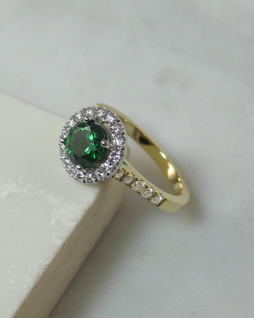An eye catching diamond and tsavorite garnet engagement ring