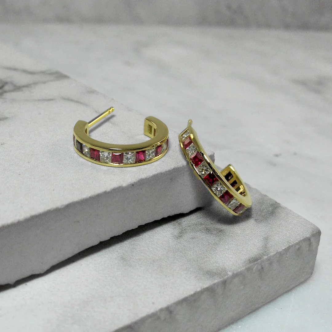 A pair of custom diamond and ruby earrings .jpg