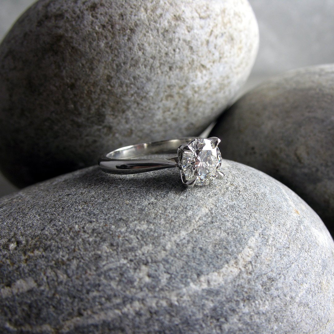 A delicate custom diamond engagement ring with tulip shaped setting