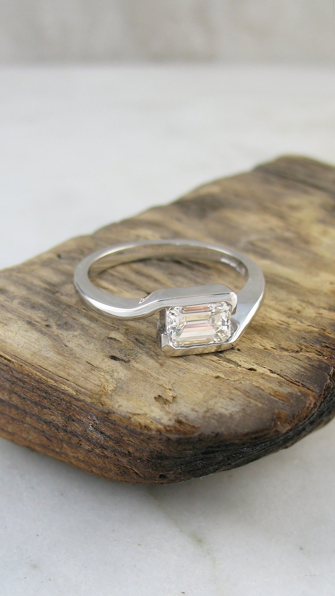 A modern style emerald cut diamond engagement ring