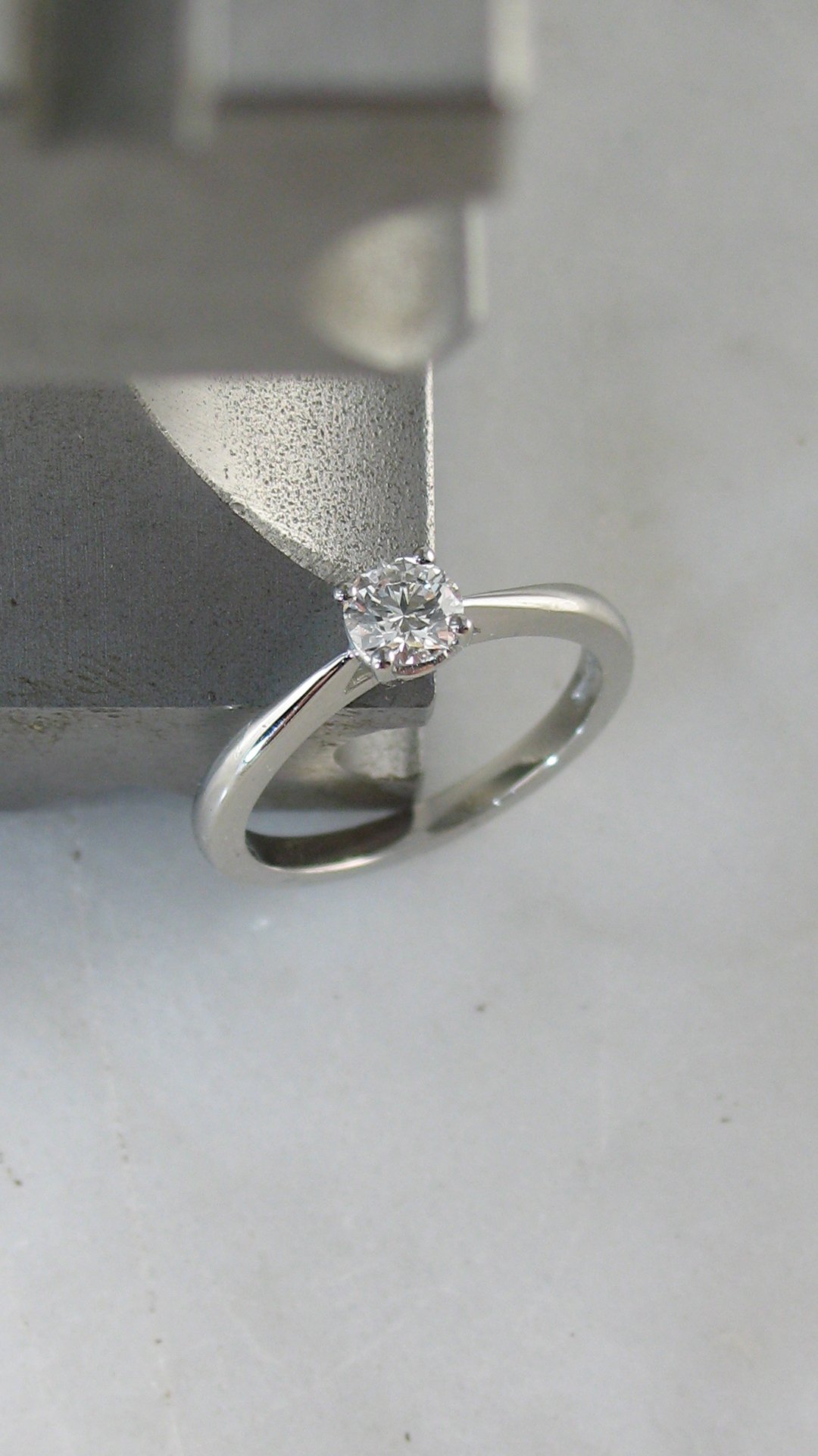 A dazzling bezel set solitaire diamond engagement ring