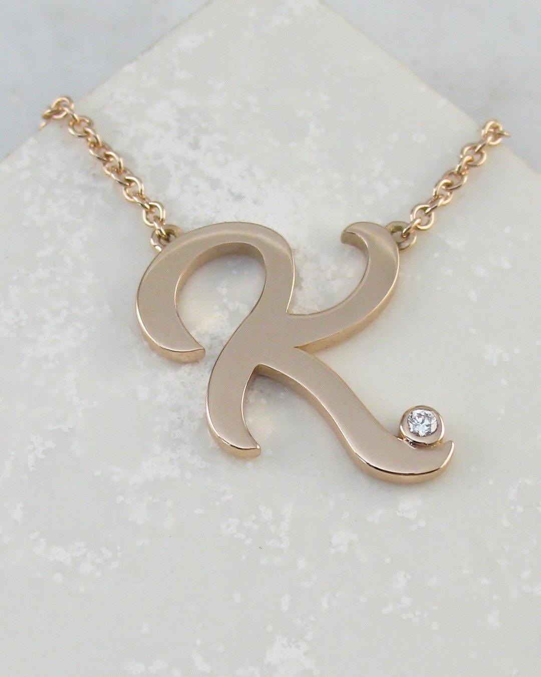 A bespoke personalised diamond letter pendants
