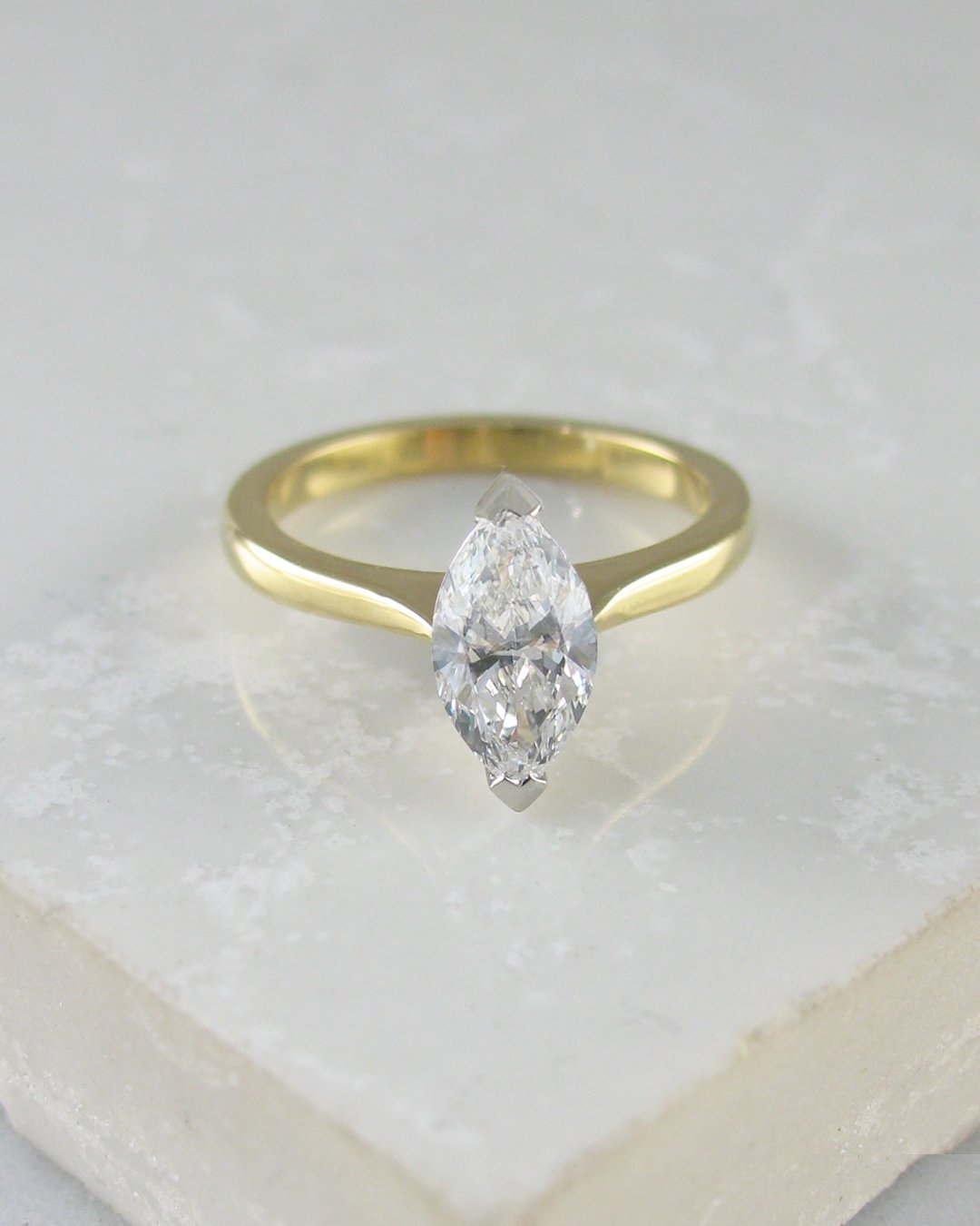 A solitaire marquise diamond engagement ring