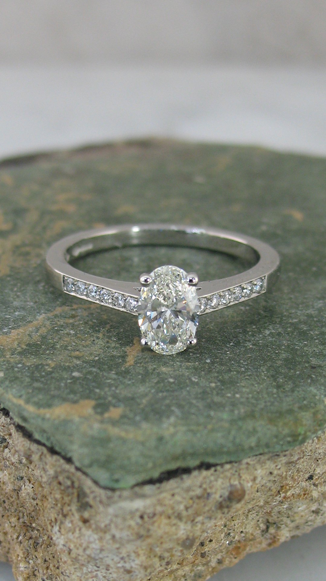 A beautiful shoulder set oval diamond engagement ring