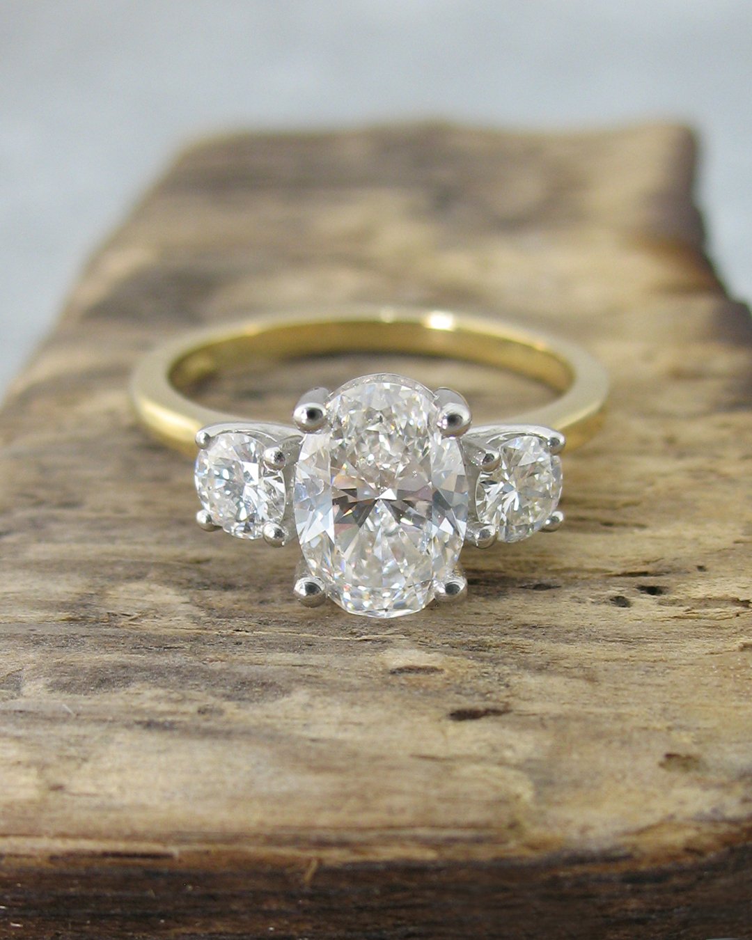 An oval shaped trilogy diamond engagement ring.jpg
