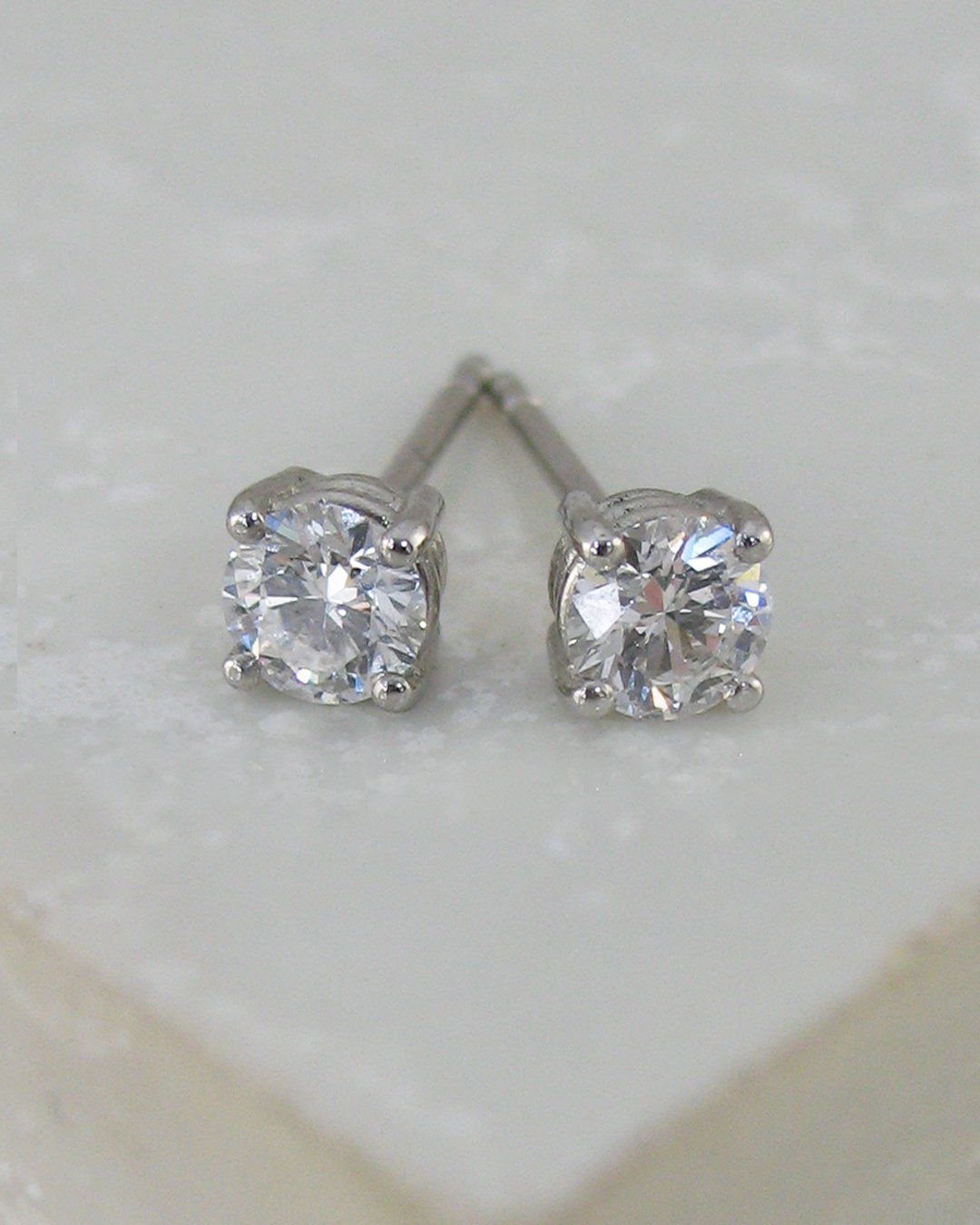 A pair of bespoke round diamond stud earrings
