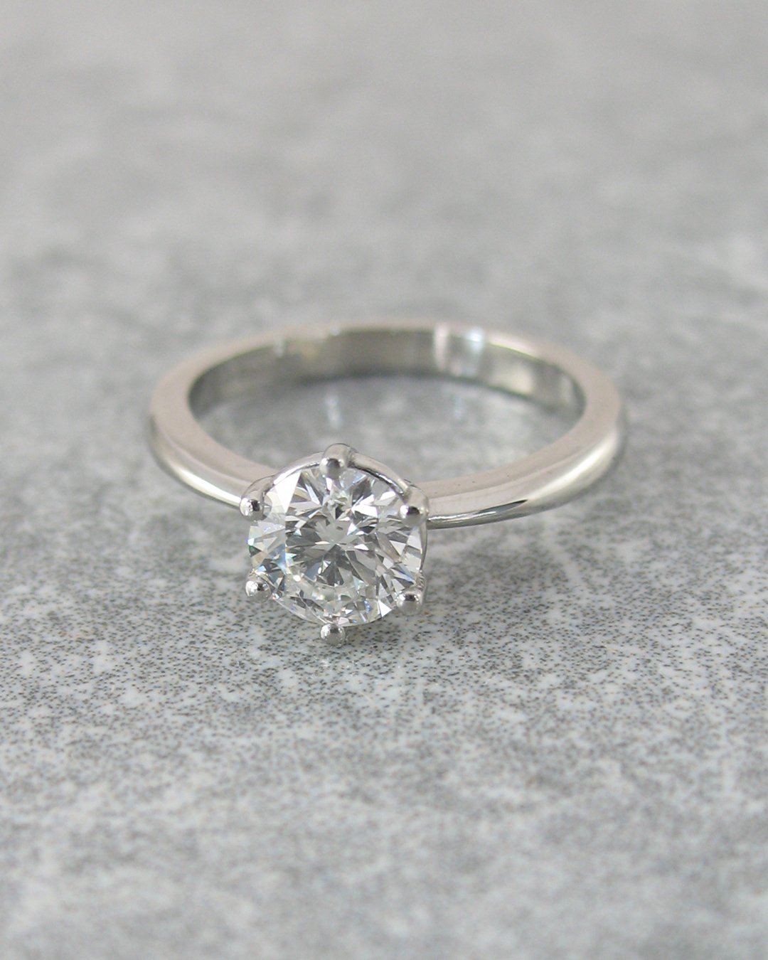 A tulip set solitaire diamond engagement ringA delicate custom diamond engagement ring with tulip shaped setting