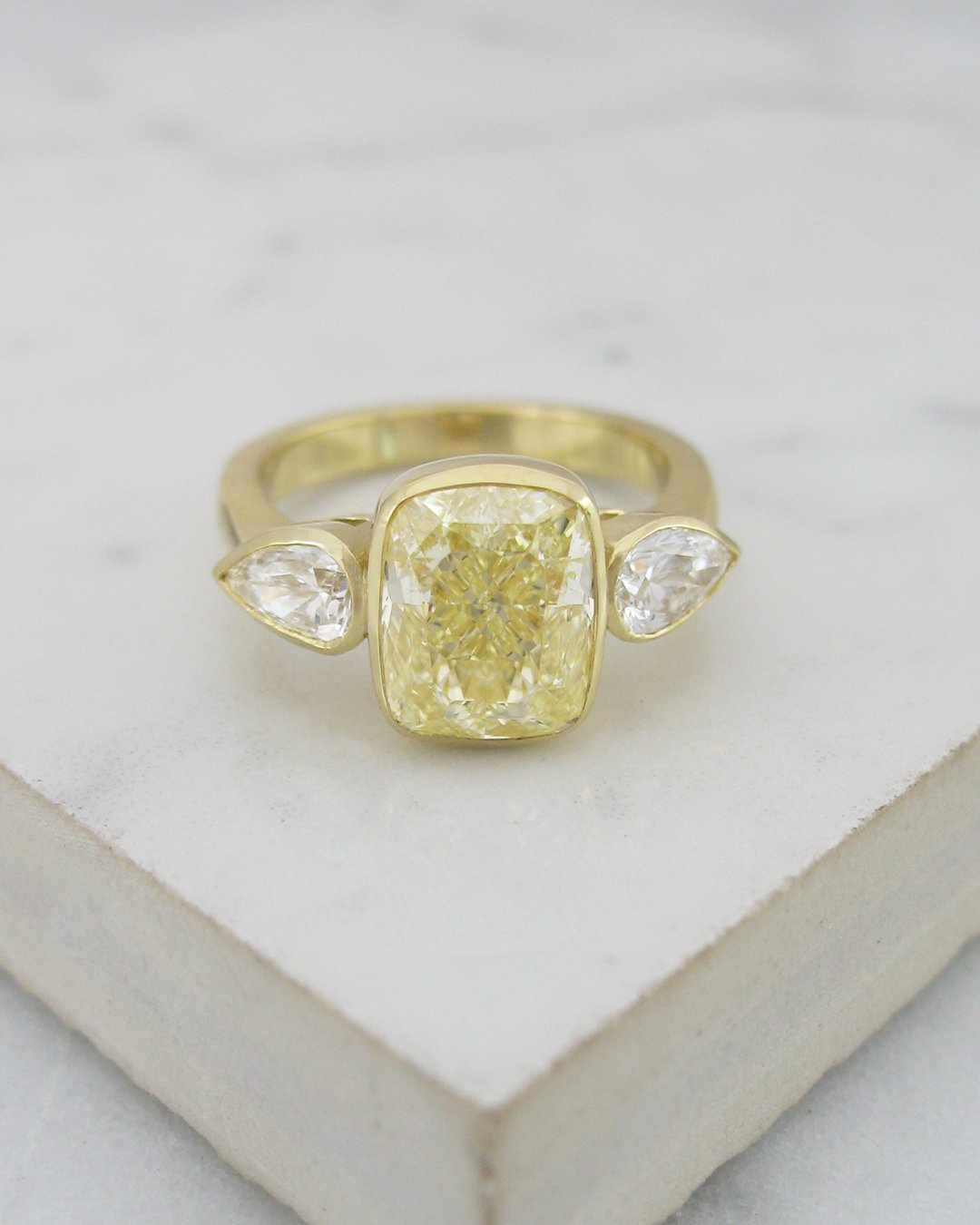 Vibrant yellow cushion cut diamond engagement ring