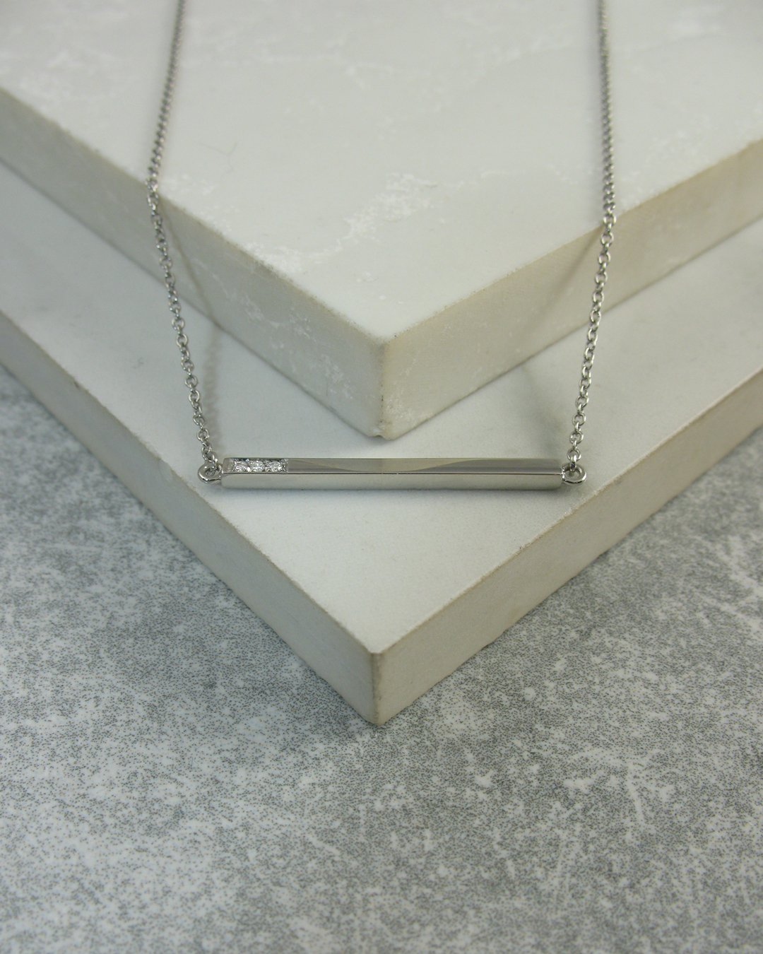 A classic contemporary style platinum and diamond pendant