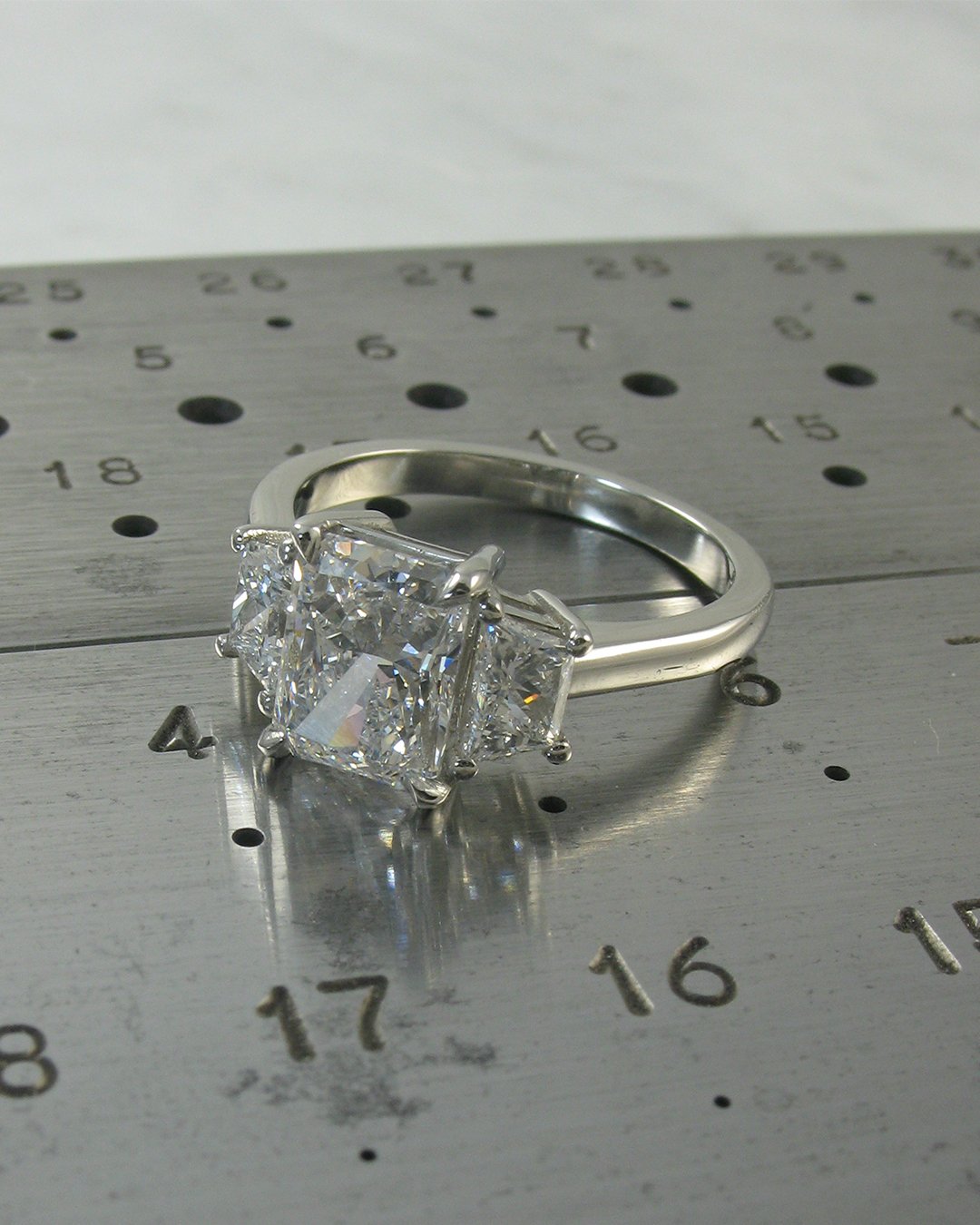 A radiant cut and trapezoid bespoke diamond engagement ring