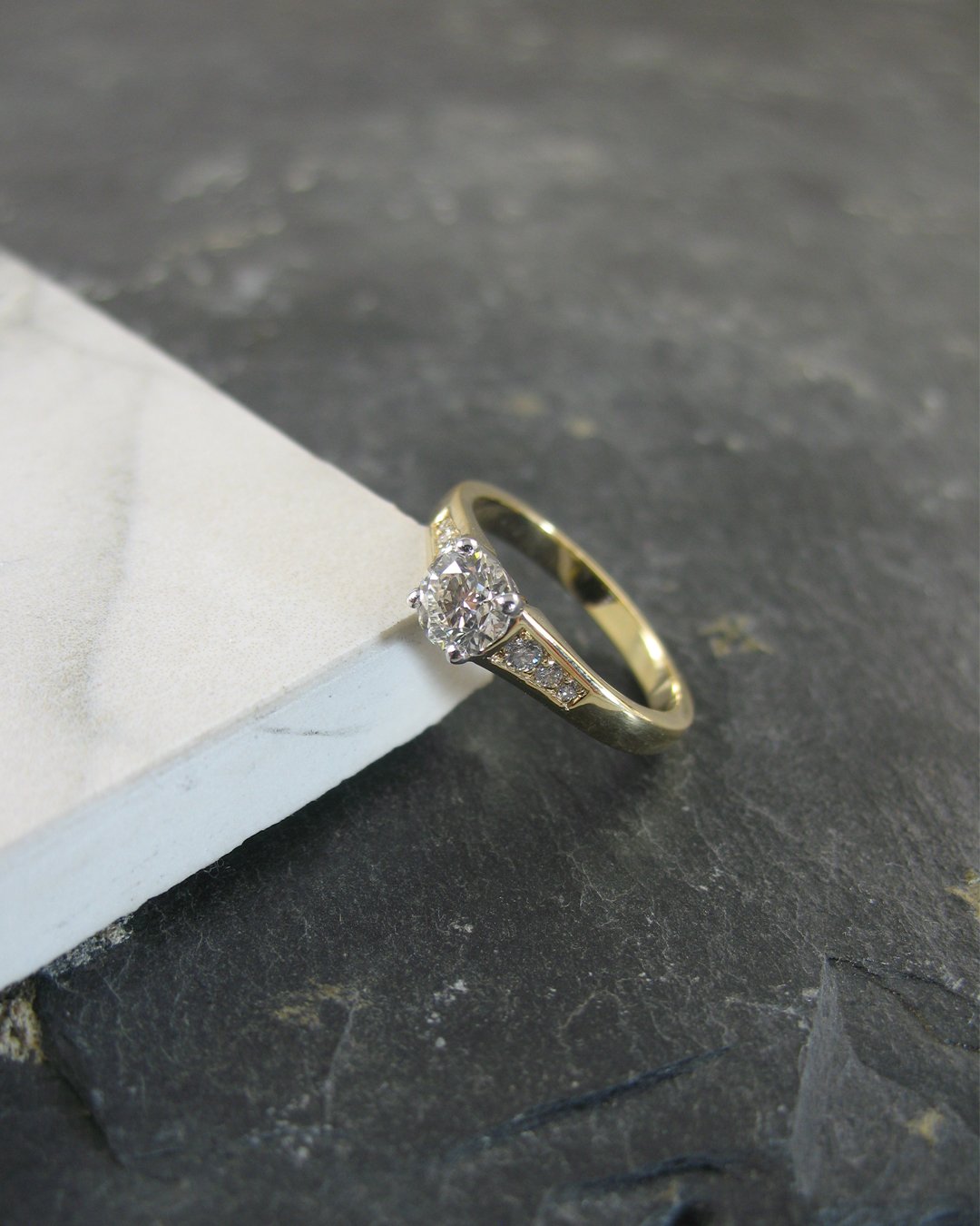 A contemporary yellow gold custom diamond engagement ring