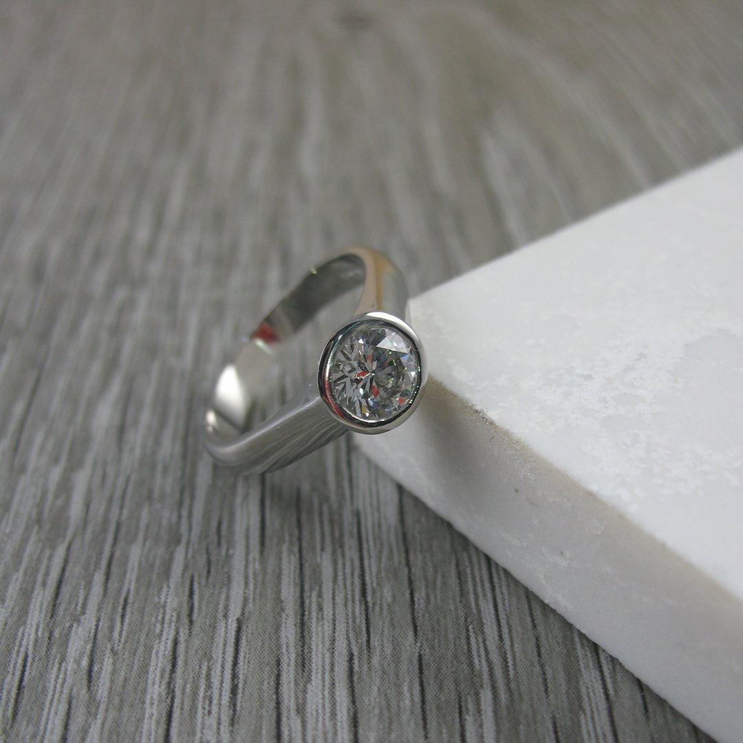A modern rub over custom diamond engagement ring