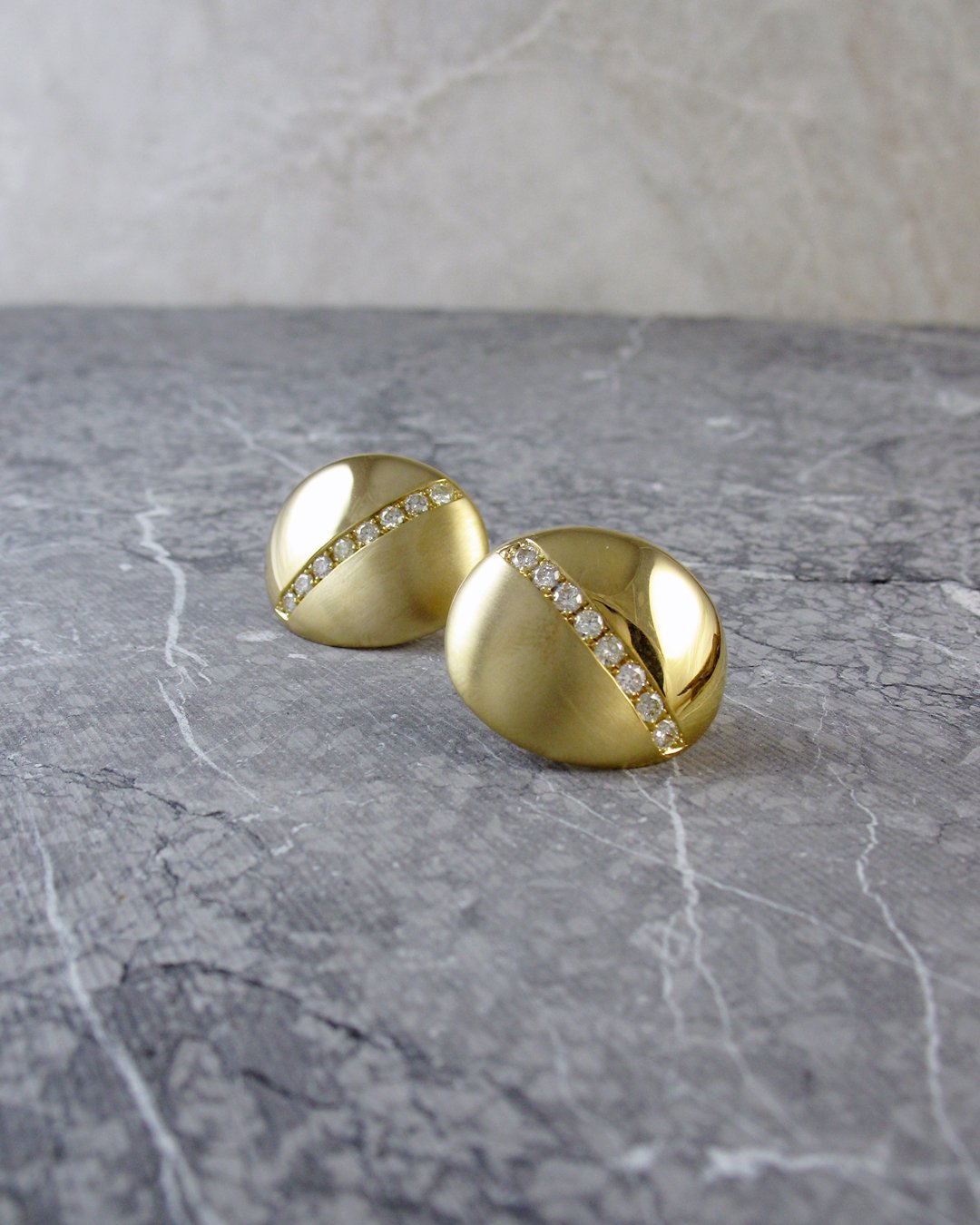 A pair of big and bold gold and diamond clip earrings