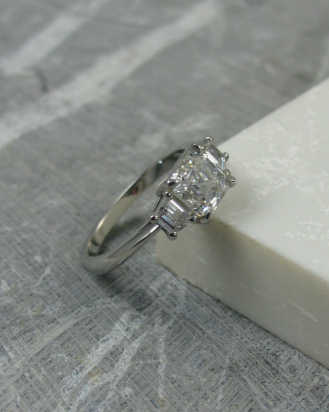 A stunning Asscher and trapezoid cut diamond engagement ring&nbsp;