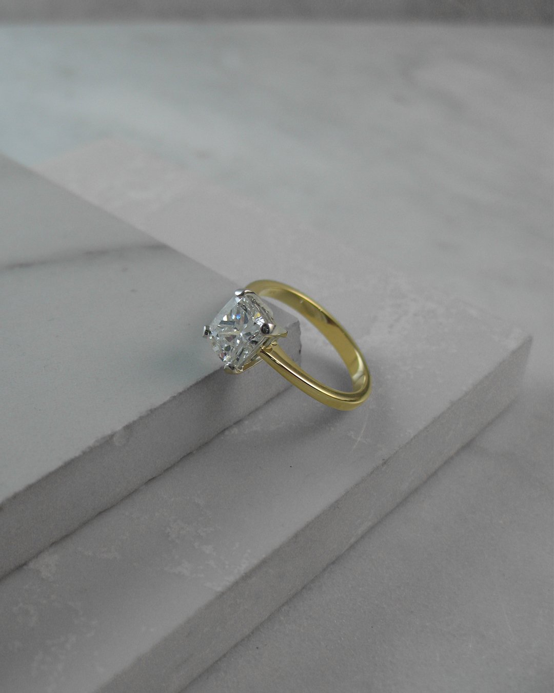 An alluring cushion cut diamond solitaire engagement ring