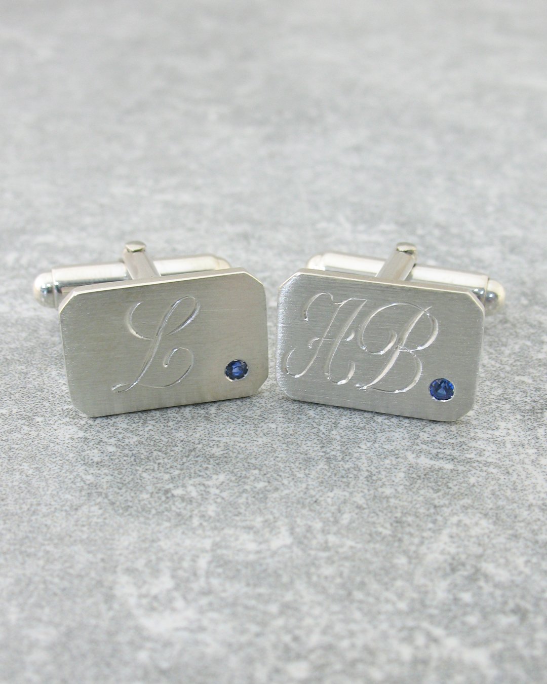 A pair of bespoke sapphire initial cufflinks