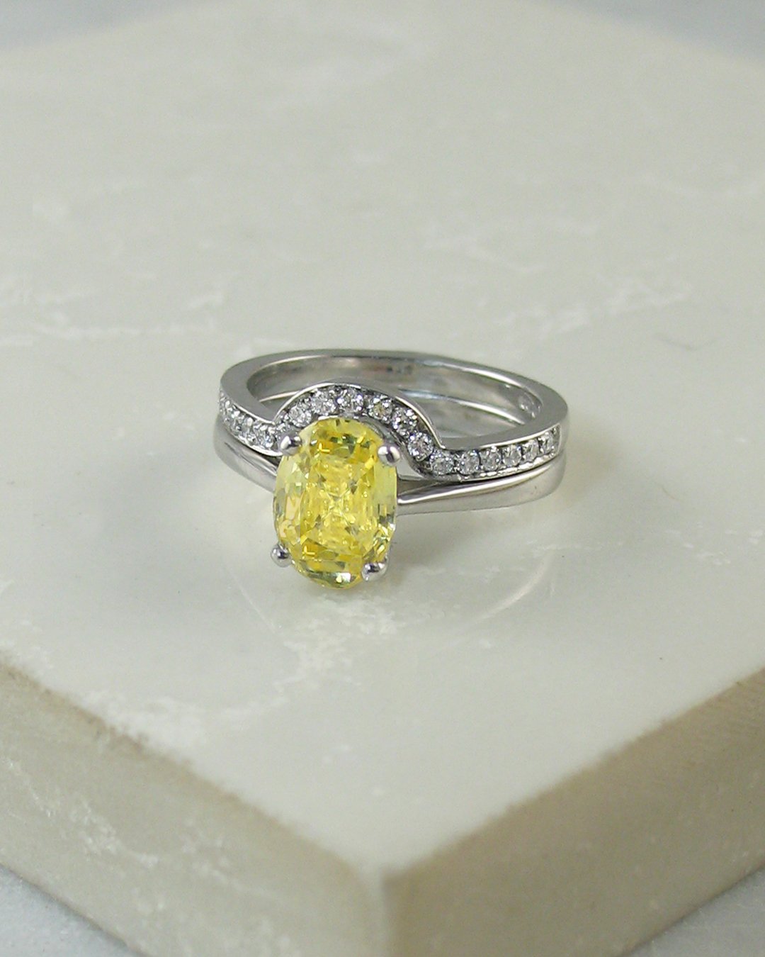 A yellow sapphire engagement ring with fitted diamond eternity ring