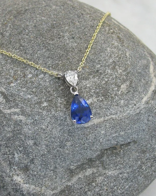A stunning pear cut sapphire and diamond drop pendant.jpg