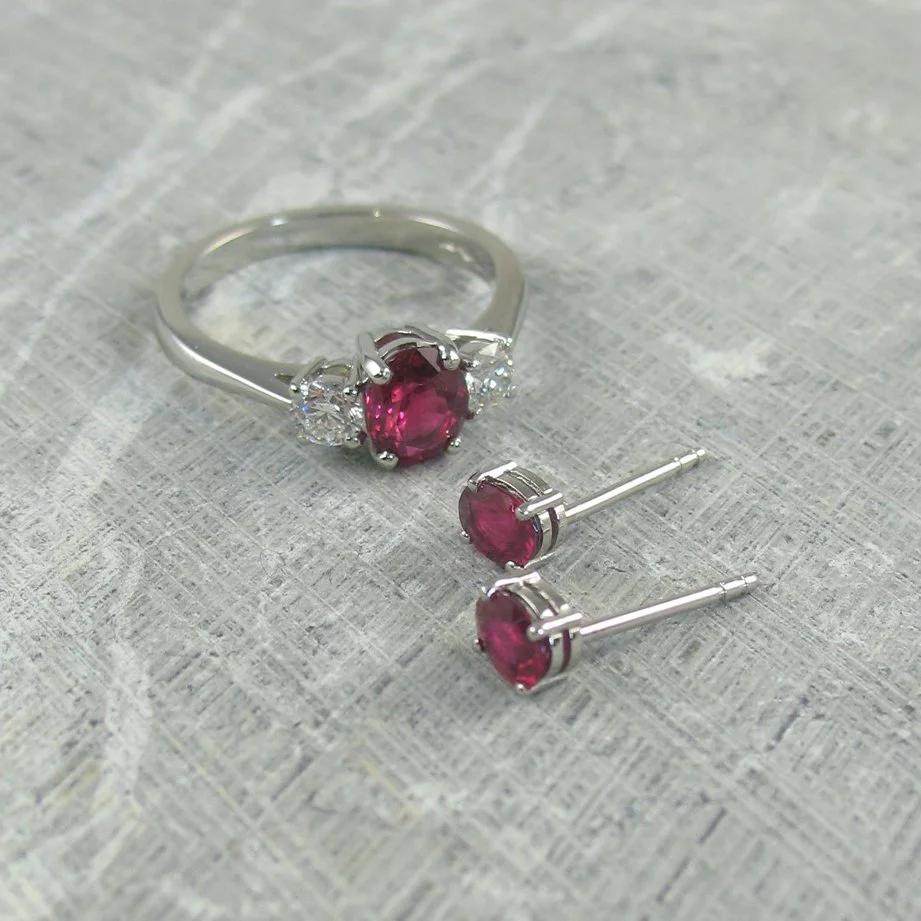 An oval ruby and diamond engagement ring with matching ruby stud earrings.jpg