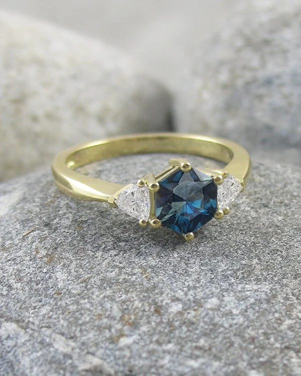 A hexagonal Montana sapphire and trilliant diamond engagment ring set in 18ct yellow gold.jpg