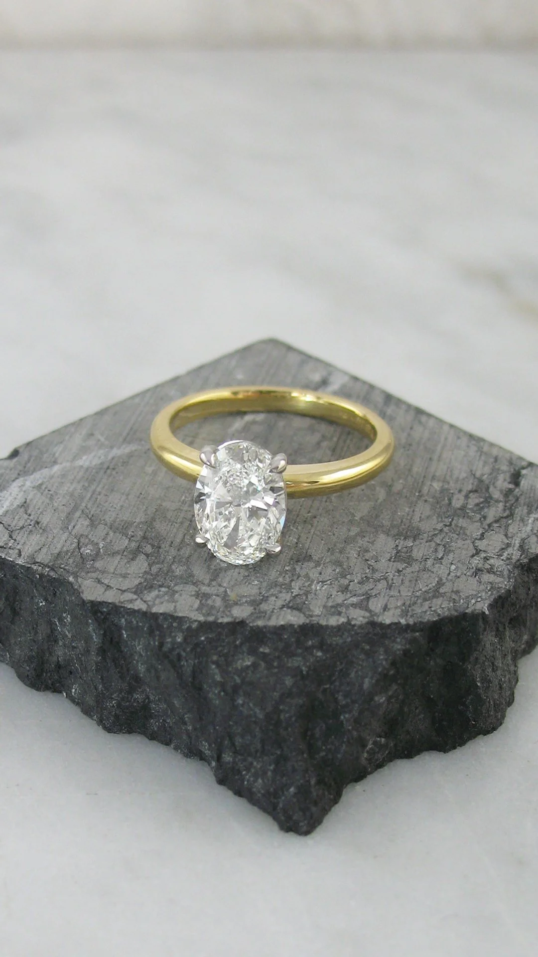 Oval solitaire engagement ring in a four claw setting
