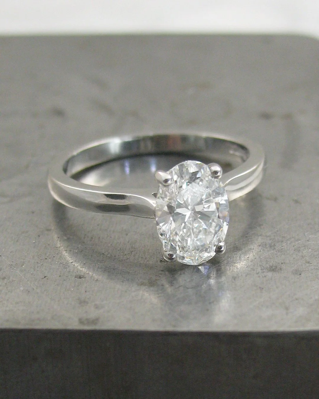Elongated oval diamond solitaire engagement ring in platinum