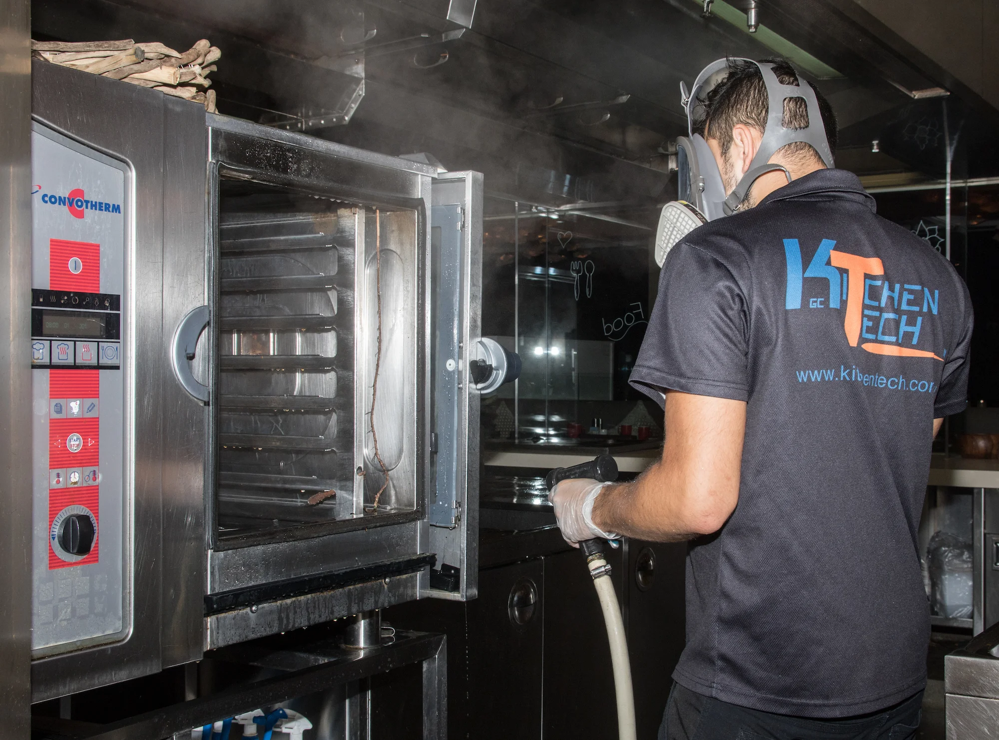 GC Kitchentech worker wearing mask heavy duty cleaning combi oven.jpg