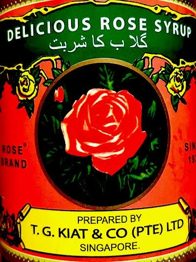 Image of an ornate tin, designed with a rose illustration and other ornate markings, and text