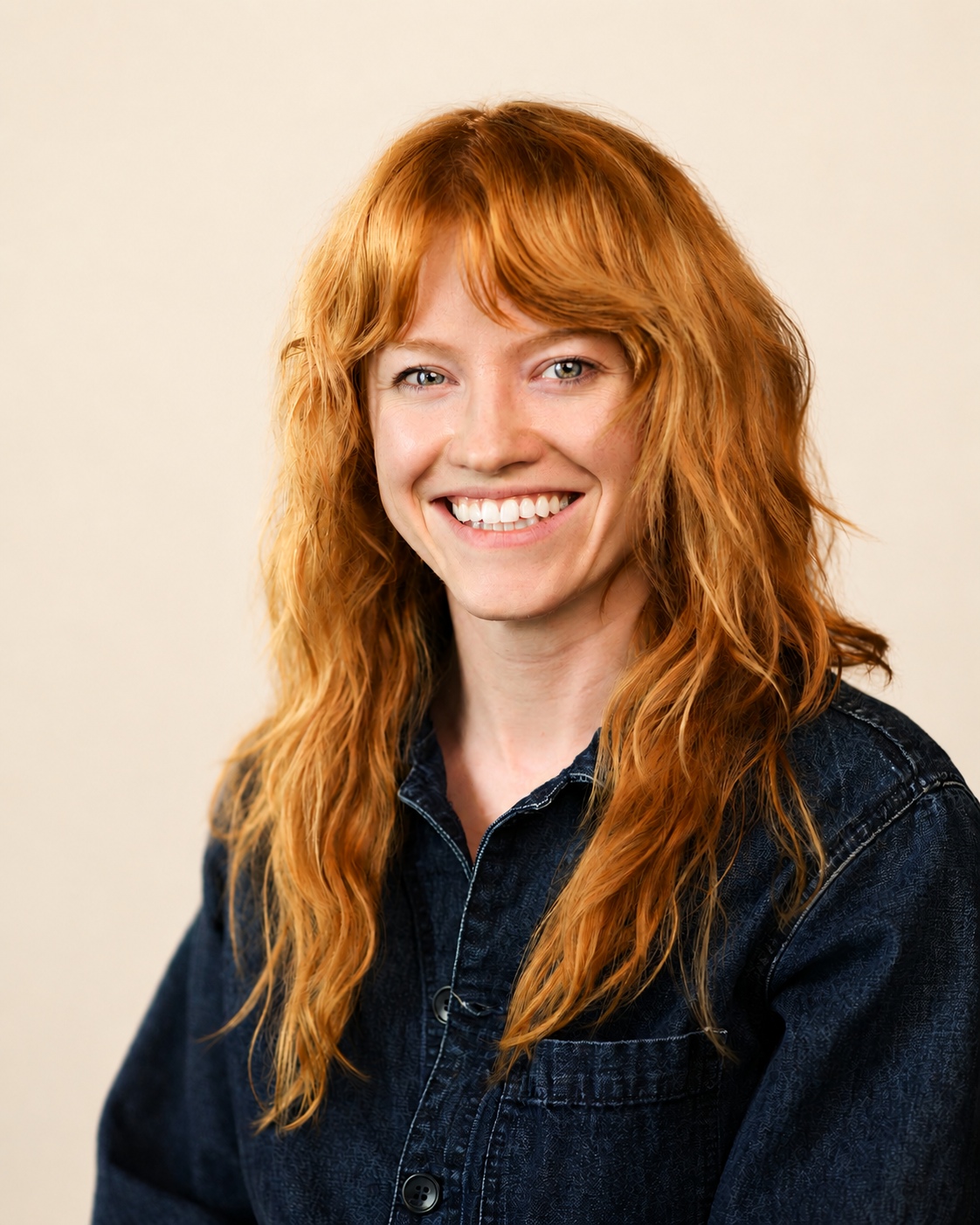 A picture of a ginger girl smiling at the camera