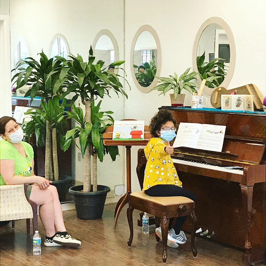 Ms. Maria works safely works with an awesome New Cottage Arts piano student!