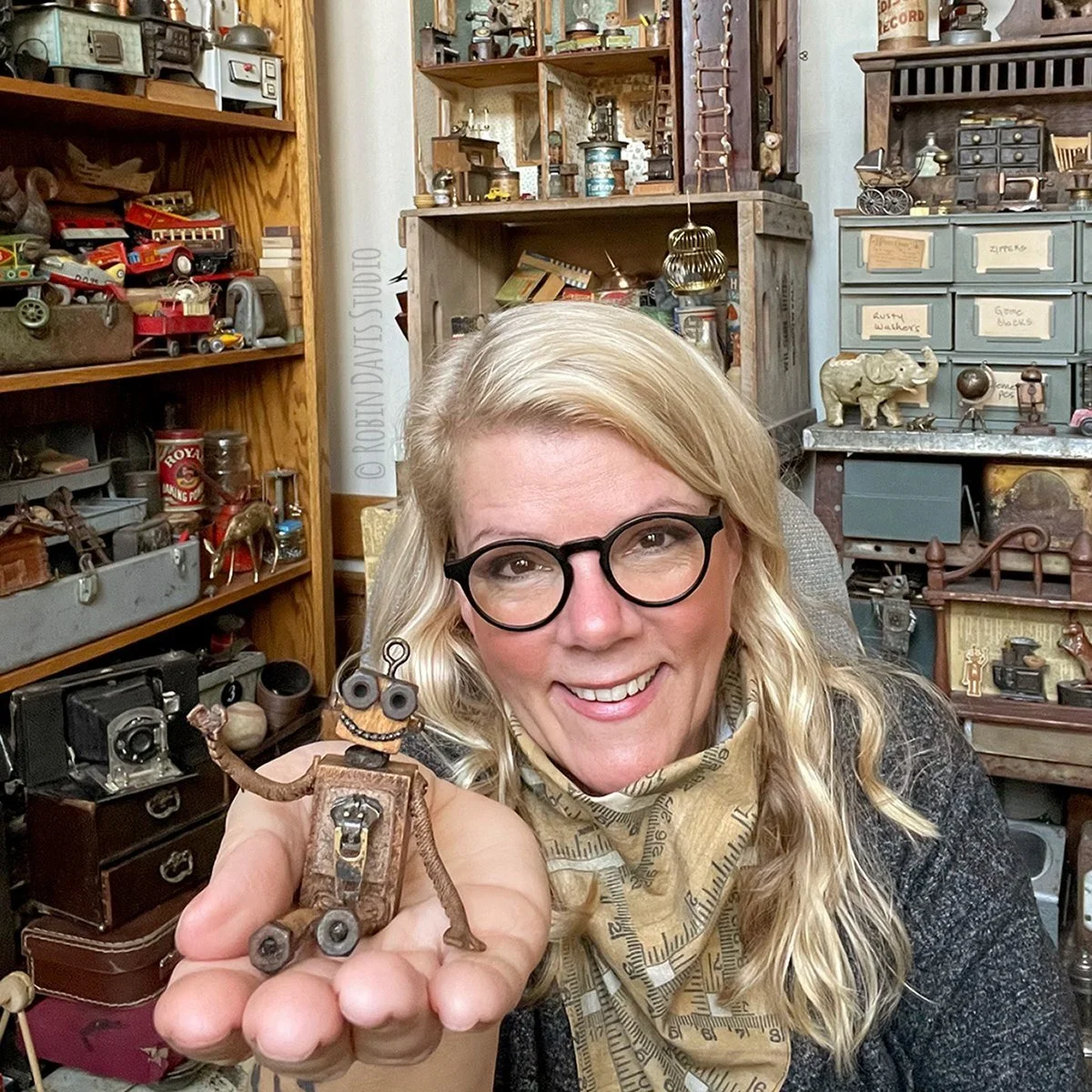 Close-up of Robin Davis and Pocket the handcrafted Botling with vintage patina and handmade miniature details