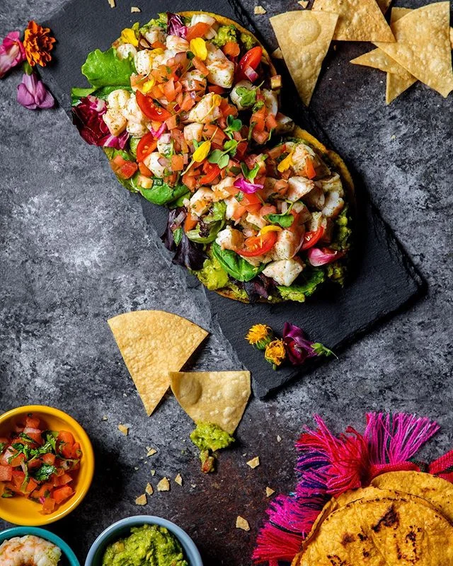 Corn tortillas are the original Mexican sustainable plate, no plate? No problem! A tostada is a cooked tortilla that is further cooked to make it crispy. The tortilla can be toasted or deep-fried. It can be cooked flat as it is, or it can have been m
