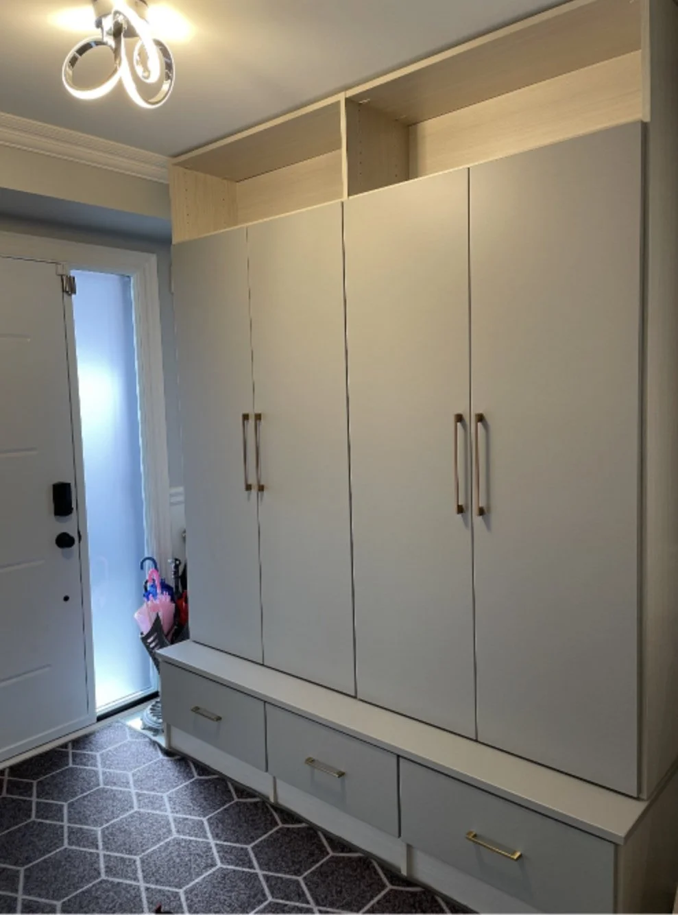 A custom built wardrobe in the entryway of a home.