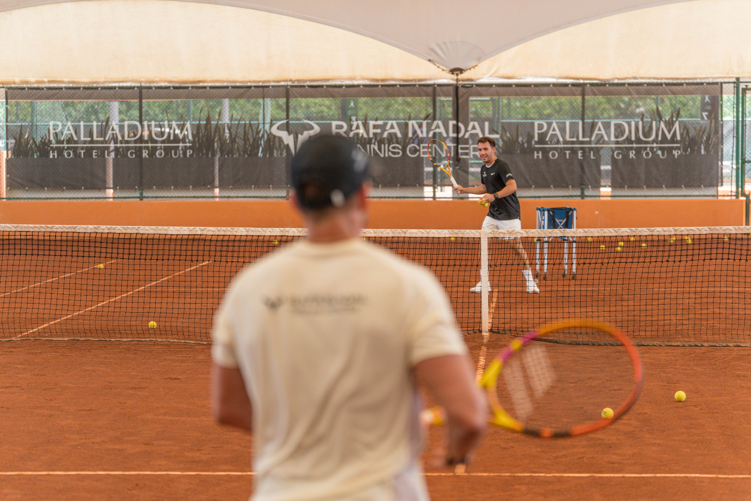 Tennis coaching session on clay court at Rafa Nadal Tennis Center Costa Mujeres Mexico